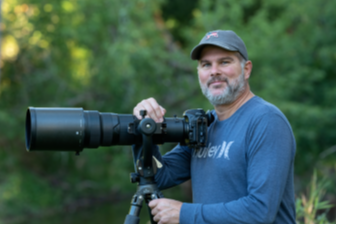 Photo of Rich next to a telescope