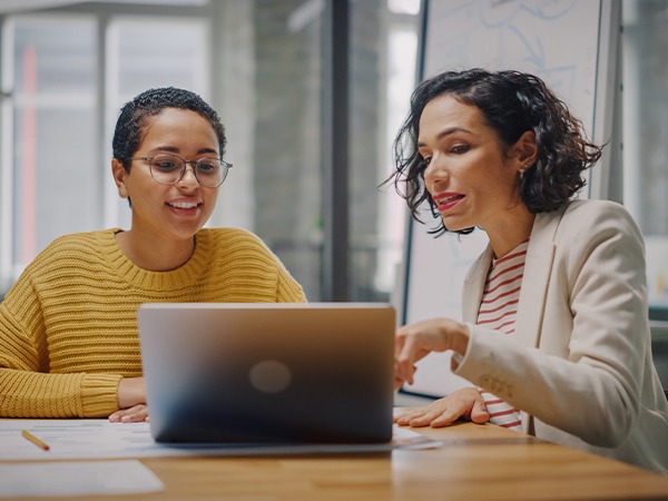 two-women-looking-at-laptop