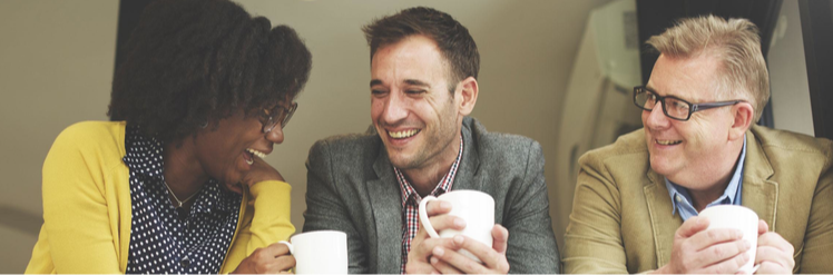 Three people holding white mugs having a meeting