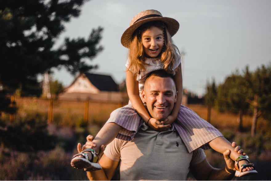 Man Carrying His Daughter On His Shoulders