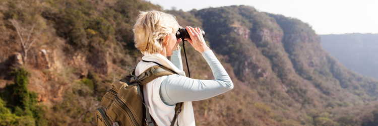 woman looking into the distance with binoculars