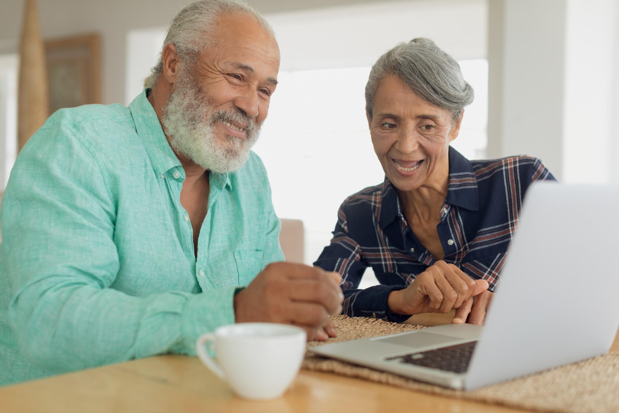 couple monitoring their investments on a laptop
