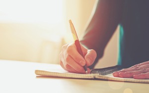Person writing in notebook