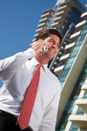 Man smiling while talking on the phone