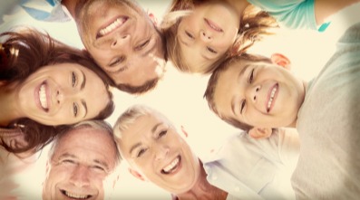 Multigenerational family smiling down at the camera