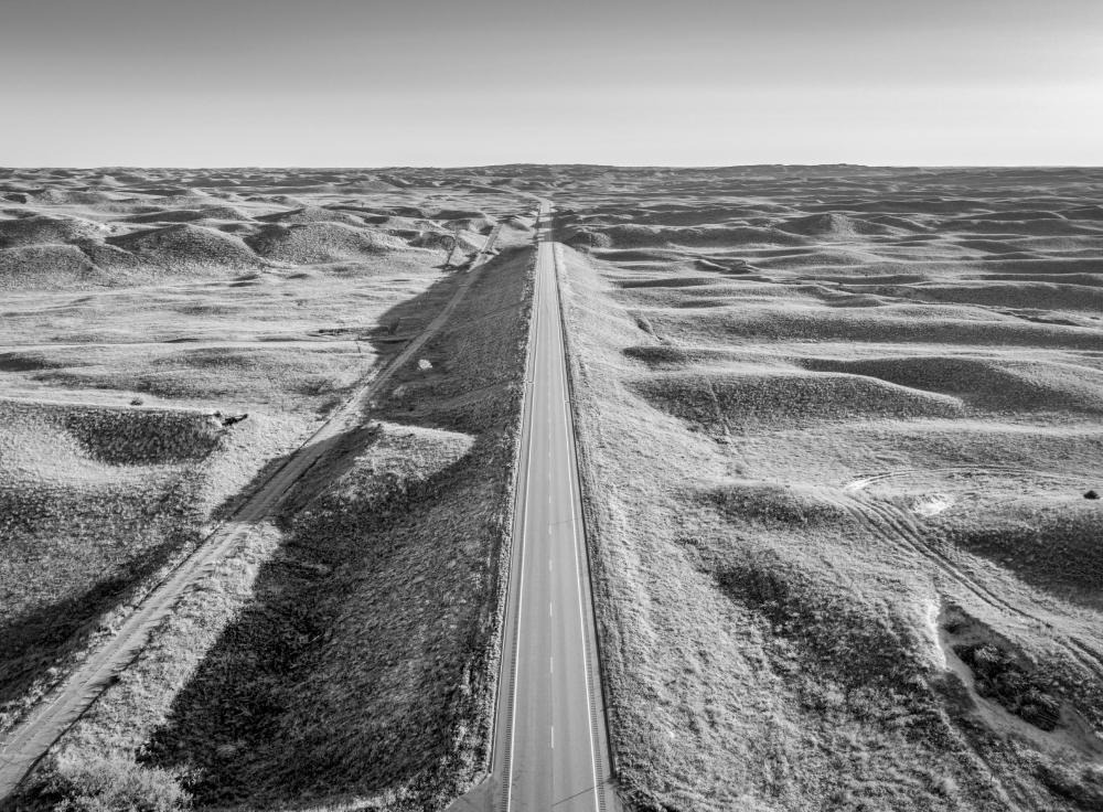 Photo of a long road in the middle of nowhere