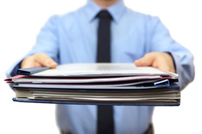 Business man handing you files