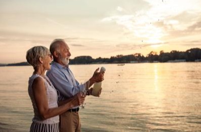 Couple celebrating at the beach with champagne