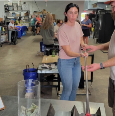 Woman glassblowing at Kinship Glassworks studio