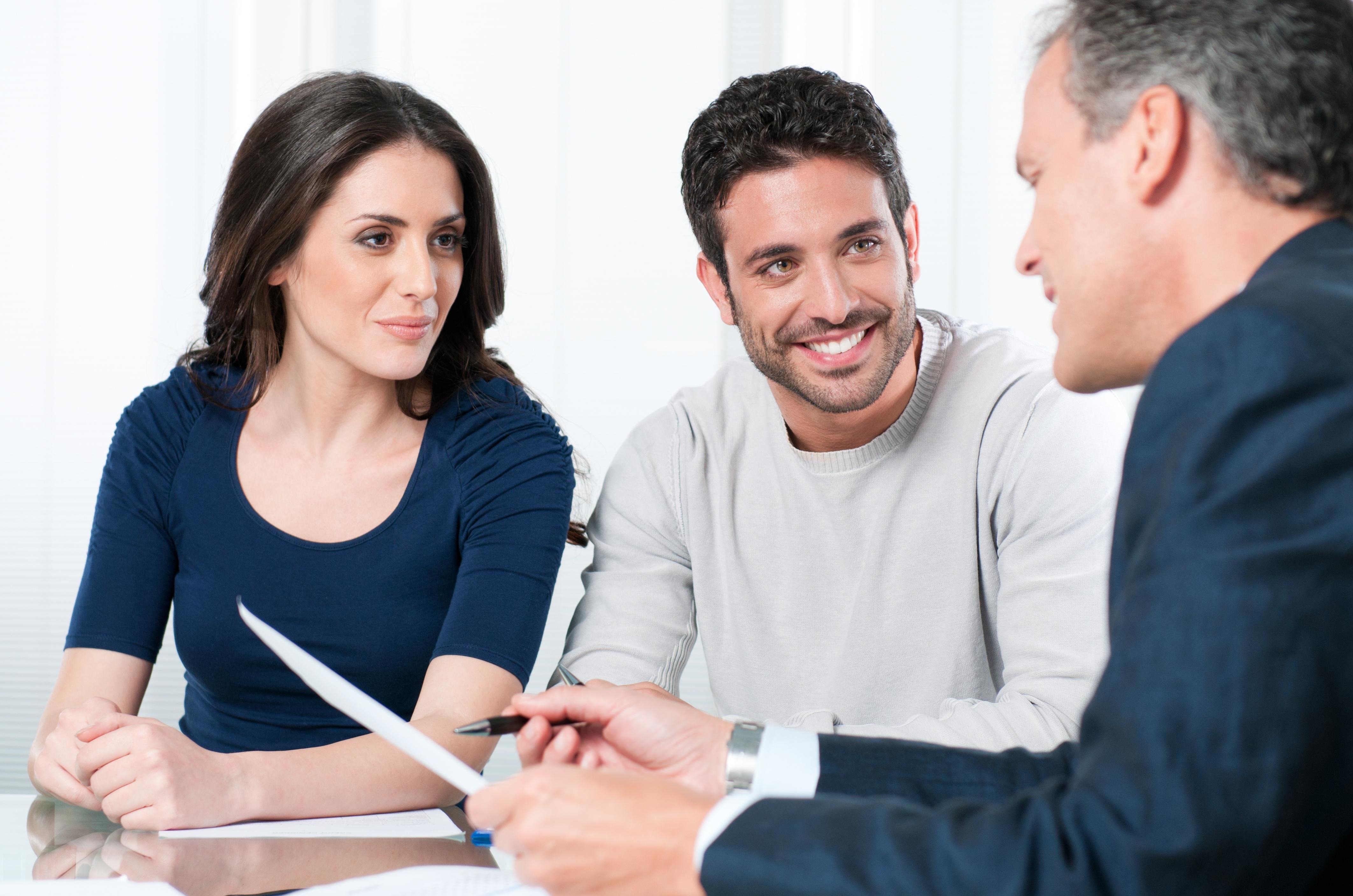 Financial consultant reviews investments with a couple