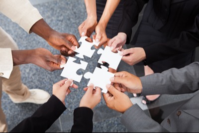Team holding puzzle pieces