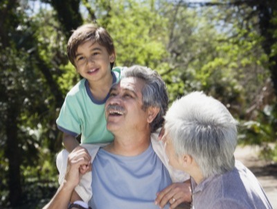 Grandparents playing outside with their grandson
