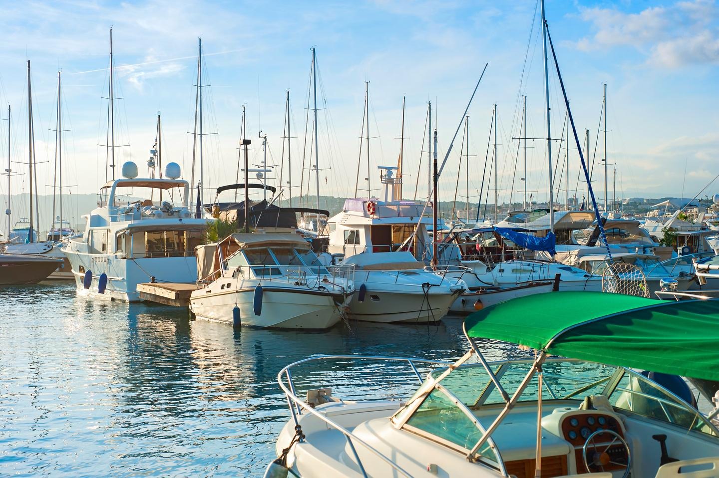 Luxury yachts in a marina at sunset