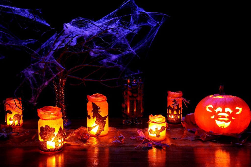 Halloween photo featuring pumpkins, spider webs, and lanterns