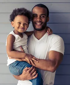 A father holding his toddler son