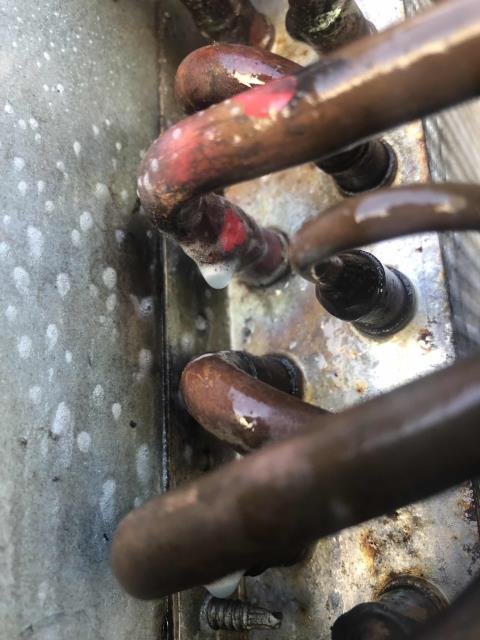 Returned to a commercial customer in Chico CA for a leak search and repair on a Lennox air conditioner. Found the bottom of the evaporator coil frozen. After thawing out the coil and performing the leak search, the technician was able to locate the leak in the u-bend of the evaporator coil. He repaired the leak and replaced the filter drier. Vacuumed and nitrogen tested to confirm no further leaks. Recharged with R22 refrigerant, system now cooling with a 23 degree temperature split. Job complete.