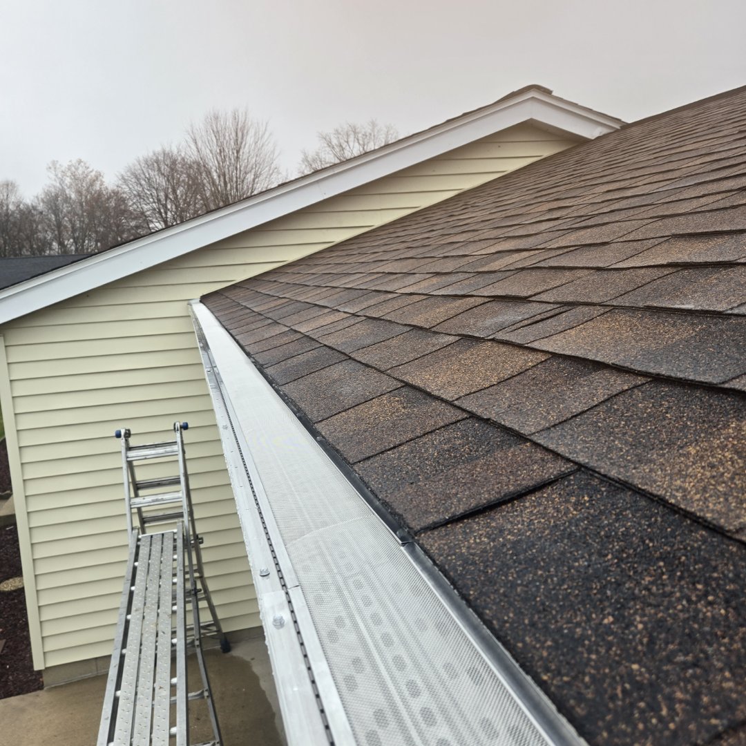 installing  Gutters and gutter cap on house 