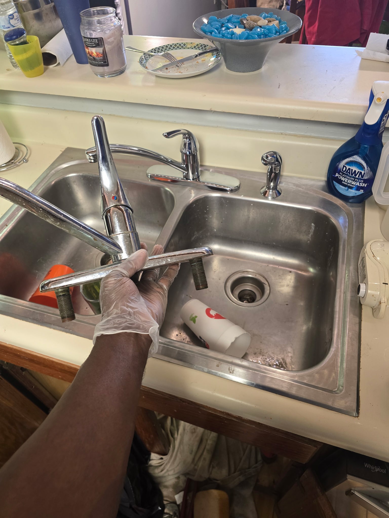 Upon arrival, I addressed a leaking toilet with heavily rusted bolts. I removed the rusted bolts, detached the toilet from the flange, and disposed of the old wax seal. New bolts and a wax ring were installed, and the toilet was securely reattached. Additionally, I replaced the old toilet fill valve with a new one. For the kitchen sink, I removed the old faucet and shut-off valves, then installed a new Moen faucet and shut-off valves. Water supply was restored, and all fixtures were tested for proper operation and no leaks.