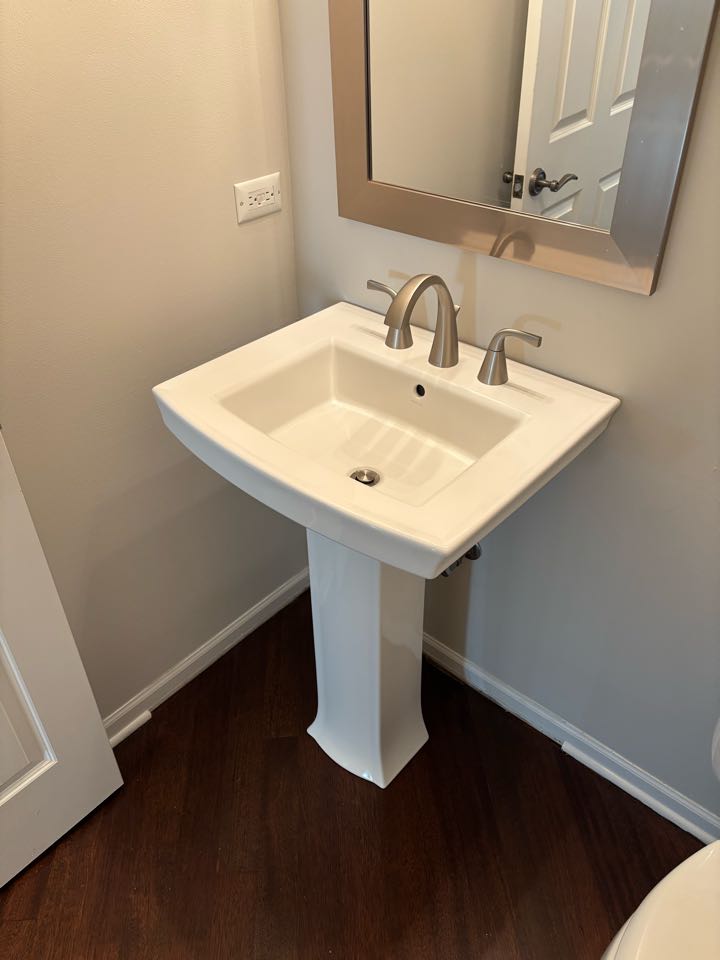 Install a new sink and faucet to complete a bathroom update. New Kohler sink and Moen faucet were provided by the customer.