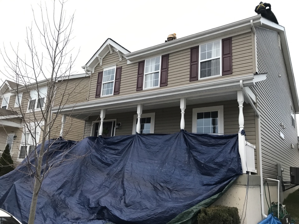 Cottleville, MO - Setting up protection to protect house from debris during roof replacement. Cottleville, MO - Setting up protection to protect house from debris during roof replacement.