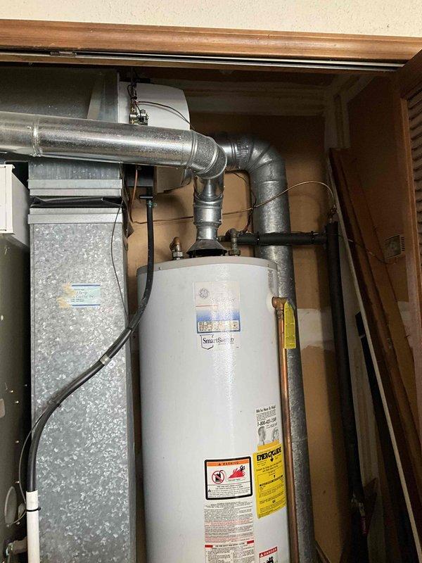 Conducted comprehensive inspection of 15+ year old furnace, A/C system, and water heater located in garage area. Equipment is currently operational but customer requested estimate for full replacement including zoning solutions for first and second floors. Documentation of existing GE SmartWater heater and connected HVAC components completed via photographic assessment to develop appropriate replacement proposal.