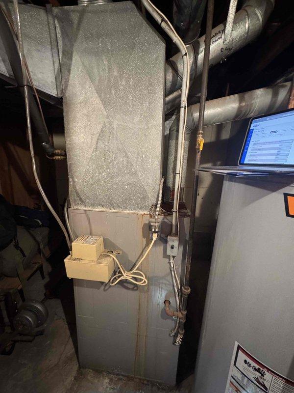 Conducted comprehensive evaluation of 30+ year old natural gas furnace system located in basement. Existing unit is functional but at end of service life expectancy. Documented current installation configuration including ductwork, ventilation lines, and electrical connections to prepare replacement estimate for modern high-efficiency system. Customer has received competing quote and is considering options for complete HVAC replacement.