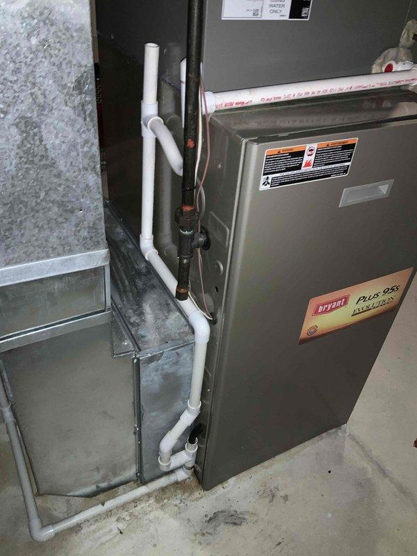 Conducted estimate for full HVAC system replacement due to non-functioning heating unit. Inspected existing Bryant Plus 95 furnace installation in utility room alongside electrical panel and water heater. Evaluated current ductwork configuration, ventilation components, and PVC condensate drain lines to determine appropriate replacement system specifications.