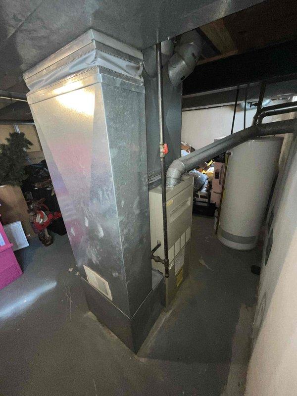 Conducted an estimate for replacement of 35-year-old natural gas furnace and tankless water heater located in basement. Existing HVAC system shows significant age-related wear with outdated ductwork configuration. Exterior inspection of condenser unit revealed potential compatibility issues with proposed new equipment.