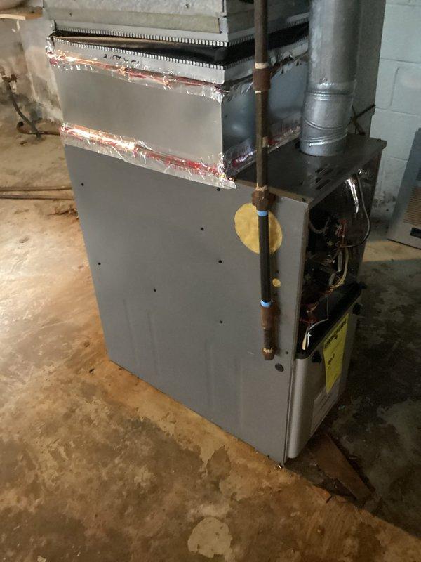 Responded to service call for insufficient airflow and heating failure. Upon inspection of basement-installed furnace of indeterminate age, diagnosed restricted airflow caused by severely clogged filter and partially blocked return air duct. Replaced filter, cleaned ductwork connections, and verified proper system operation with restored airflow and heating function.