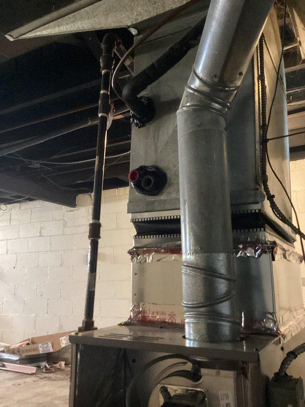 Responded to service call for insufficient airflow and heating failure. Upon inspection of basement-installed furnace of indeterminate age, diagnosed restricted airflow caused by severely clogged filter and partially blocked return air duct. Replaced filter, cleaned ductwork connections, and verified proper system operation with restored airflow and heating function.