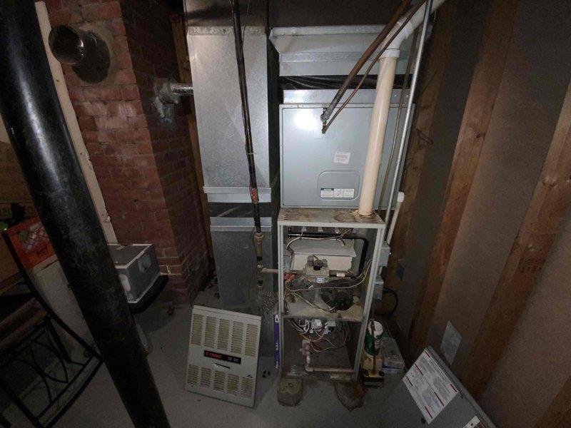 Performed inspection and estimate for replacement of aging 30-35 year old furnace and A/C system located in basement. Current equipment is operational but nearing end of serviceable life. Noted deteriorated wiring connections in control box and signs of wear on main furnace components. System replacement recommended due to equipment age and to improve energy efficiency.