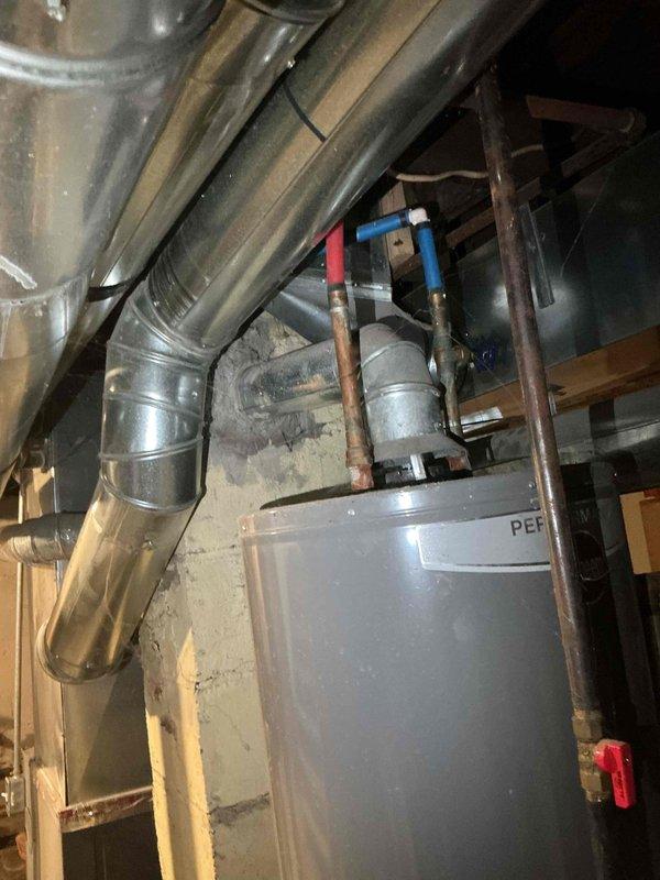 Performed comprehensive evaluation of 10-15 year old natural gas forced air system located in basement. Inspected electrical panel for proper capacity to support replacement system. Assessed existing ductwork configuration and connection points, noting current installation includes galvanized steel ducting with hot/cold water lines featuring color-coded connectors. Prepared estimate for complete furnace and air conditioning replacement.