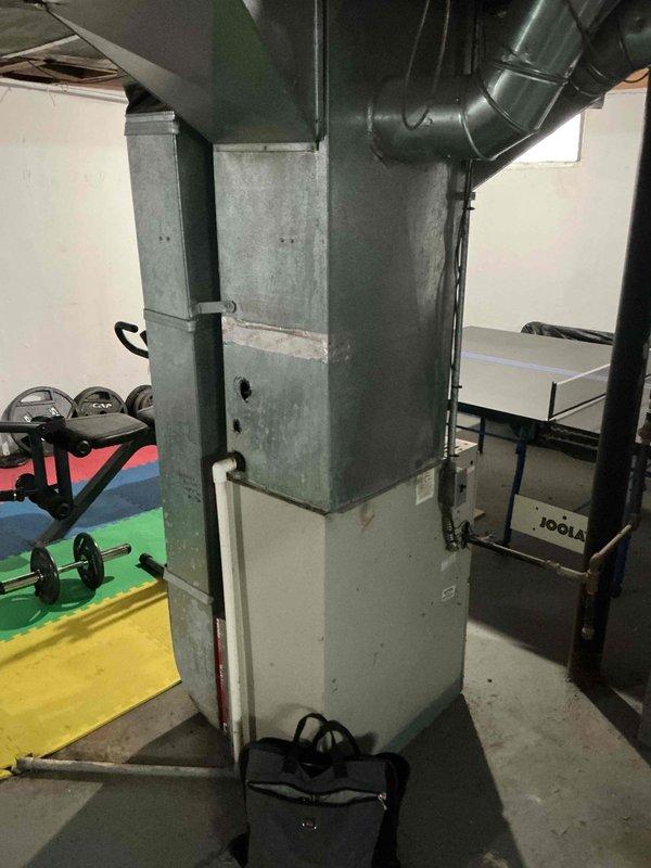 Conducted an HVAC replacement estimate for a 15-year-old non-operational furnace and AC system located in the basement. Evaluation included inspection of the existing natural gas furnace with connected ductwork and assessment of the surrounding installation environment, which features adequate space despite sharing the area with recreational equipment.