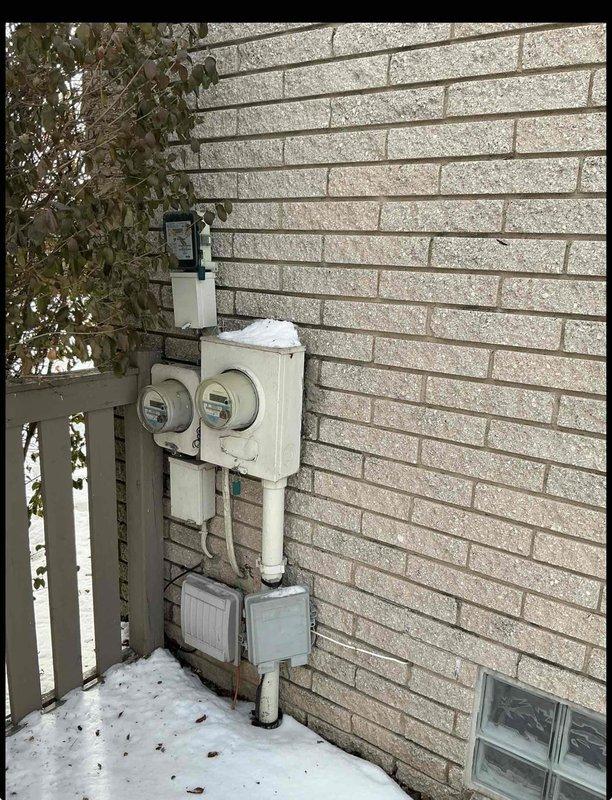 Conducted assessment for furnace and A/C replacement in basement location. Current heating system non-operational at 31 years of age. Documented exterior electrical service configuration and interior plumbing/framing elements to evaluate installation requirements for new HVAC system.