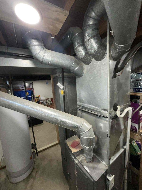 Conducted comprehensive assessment of non-operational 15-year-old HVAC system located in basement, including water heater and air conditioning unit. Documented existing equipment condition through detailed photography, noting extensive galvanized ductwork configuration and current system integration with home infrastructure to prepare accurate replacement estimate.