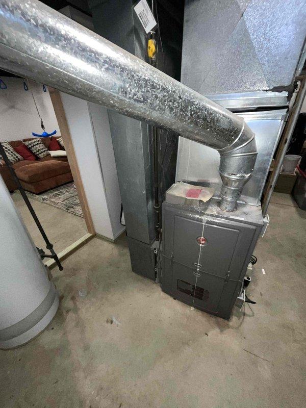 Conducted comprehensive assessment of non-operational 15-year-old HVAC system located in basement, including water heater and air conditioning unit. Documented existing equipment condition through detailed photography, noting extensive galvanized ductwork configuration and current system integration with home infrastructure to prepare accurate replacement estimate.