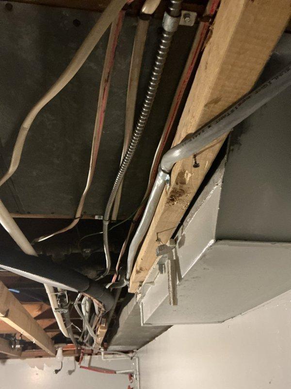 Completed violation repair by installing electrical panel cover with properly labeled circuits and installing code-compliant GFCI service receptacle for AC unit. Visual inspection of basement/crawlspace area confirmed proper installation of electrical components and connection to existing HVAC system.