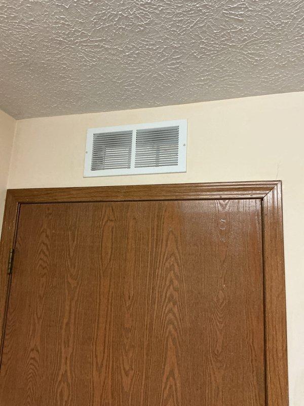 Performed callback service for previously installed furnace and AC system, installing transfer grills above door and in soffit to address combustion air requirements per manufacturer specifications. Documented B-vent leakage causing water on furnace top requiring immediate attention to prevent equipment damage. Provided replacement 16"x20"x1" filters as courtesy for customer inconvenience.