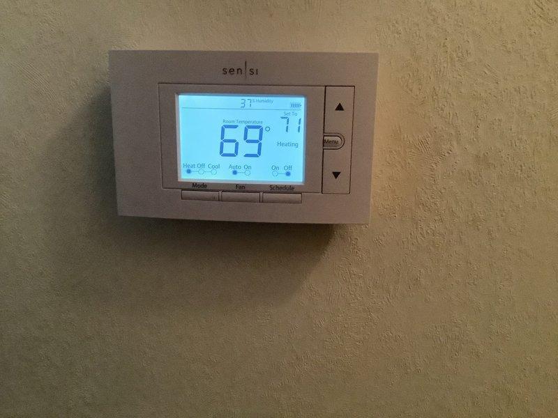 Performed diagnostic inspection of furnace system per previous assessment. Examined burner assembly/igniter component showing signs of heat exposure and wear. Verified Sensi thermostat operation (displaying 69°F, 37% humidity) with heating function active.