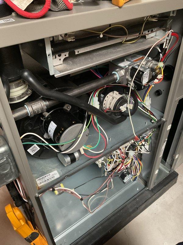 Performed annual heating maintenance service on the residential HVAC system. Conducted thorough inspection of the furnace unit, examining internal components including blower motor assembly, electrical connections, and ventilation system. System was found to be in good working condition with proper installation of PVC exhaust pipes and appropriate ductwork connections.