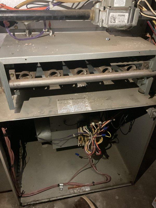 Performed scheduled AHM service on furnace unit. Inspected control components, heat exchanger assembly, and electrical wiring harness. Noted some dust accumulation on interior surfaces but system appears to be functioning normally with all connections secure.