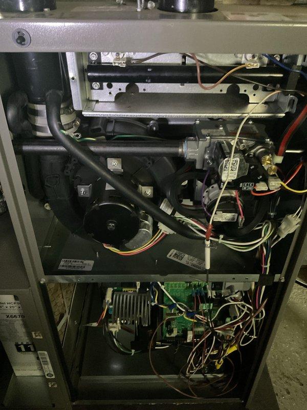 Performed annual HVAC maintenance on Lennox furnace system. Inspected interior components including motor assembly, control board, and electrical connections. All components functioning properly with no issues observed in wiring or mechanical parts. System has proper venting with PVC exhaust pipes and appropriate ductwork connections.