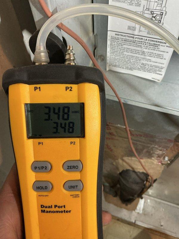 Replaced faulty gas valve in furnace with new unit. Verified proper installation with dual port manometer testing, confirming appropriate gas pressure readings of 348 on both ports. System now functioning correctly with all connections secure and operational.