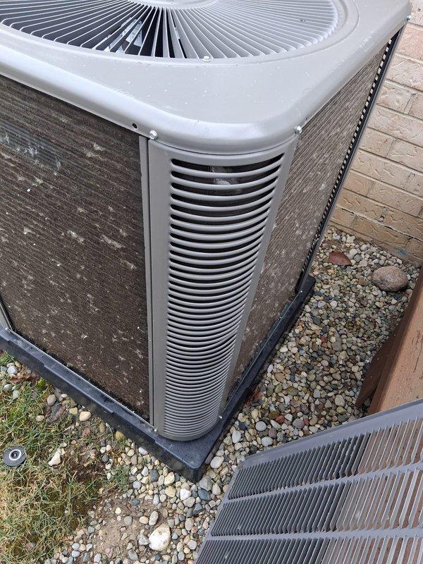 Performed scheduled Air Care Cooling and Heating maintenance service on the outdoor AC/heat pump unit. Inspected system components, noting weathered exterior with dirt buildup on housing and ventilation fins. Replaced filter and pad as part of regular maintenance protocol.