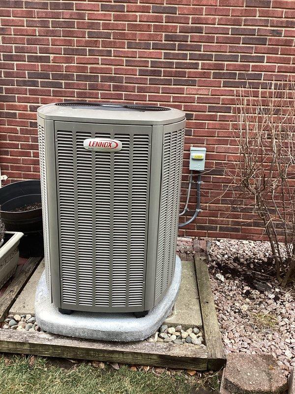 Completed installation of a complete HVAC system including a 135,000 BTU furnace, 5-ton Lennox air conditioning unit, and new hot water heater. System includes properly installed condensate drainage with PVC piping and P-trap configuration, with the outdoor AC unit mounted on a concrete pad with appropriate electrical connections.