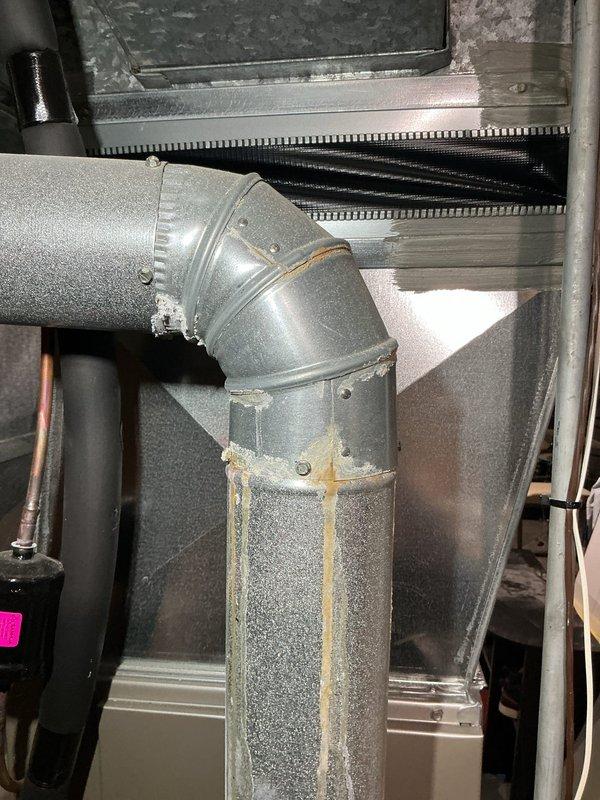Performed diagnostic on 12-year-old non-operational furnace located in basement. Inspection revealed significant corrosion on ductwork connections and elbow joints with visible rust streaks indicating possible condensation issues. Identified damaged components in the motor/fan assembly that required replacement to restore proper functionality.