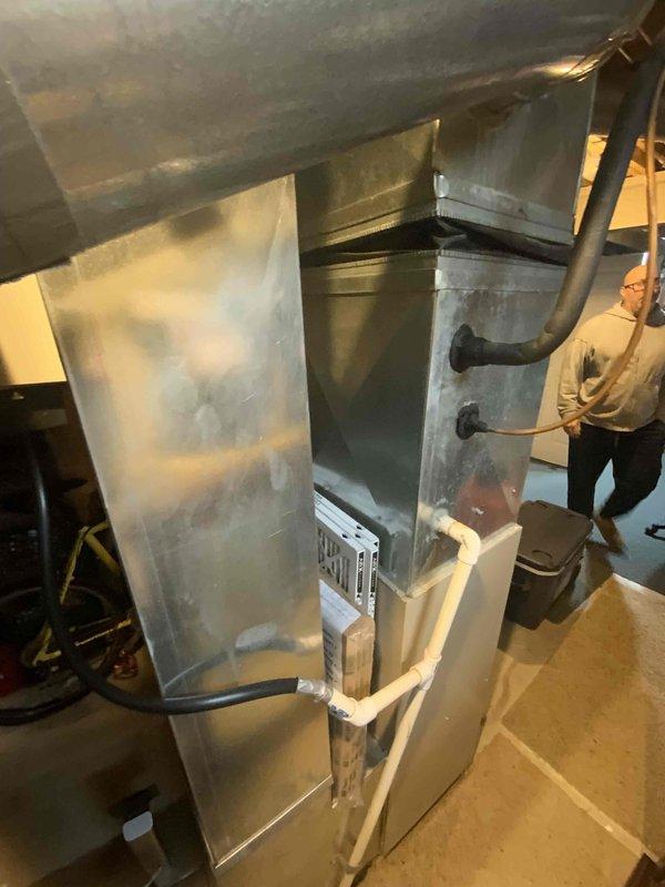 Conducted evaluation of 26-year-old functional furnace and A/C system located in basement. Inspection revealed aging copper piping infrastructure with brass valve assembly and associated ductwork. Recommended replacement of existing HVAC system with new equipment to improve efficiency and reliability before end of service life.