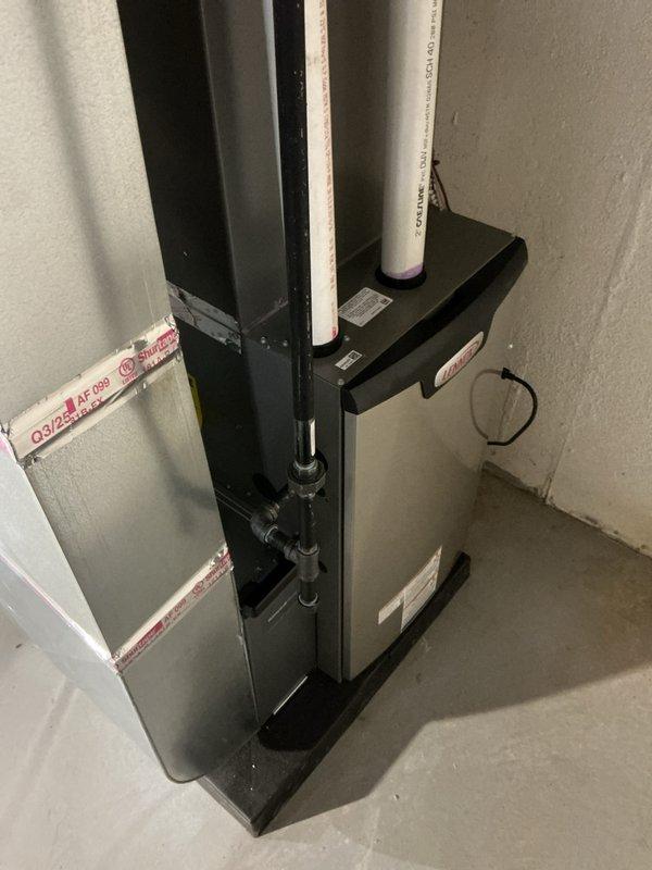 Successfully installed a complete HVAC system including a 70,000 BTU furnace and 2.5-ton air conditioning unit with proper mechanical and electrical connections. System features dual PVC ventilation pipes and includes all necessary plumbing components with copper piping and control valves for optimal operation.