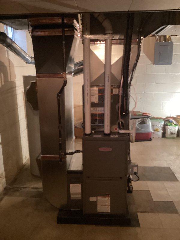 Successfully installed a complete HVAC system consisting of a 70K BTU furnace, 2-ton air conditioning unit, and humidifier in the customer's basement. System includes proper PVC venting, ductwork connections, and electrical hookups, with all mechanical and electrical permits secured prior to installation.