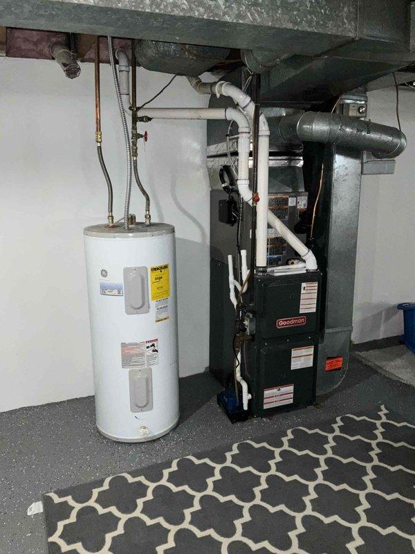 Conducted assessment of existing GE water heater installed in residential basement utility area. Noted proper copper pipe connections and placement adjacent to Goodman furnace system. Documented CA LEAD03/164-6 HWT installation with anticipated replacement timeline of 09/2025.